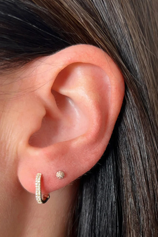 model wearing Diamond Lola Huggie Earring (Pair) yellow gold Diamond Lola Huggie
Two rows of pavé diamonds
Diamond weight: 0.12 carats for the pair
Earring height: 12 mm
Huggie inner diameter: 7.5 mm
Finished with a latch closure