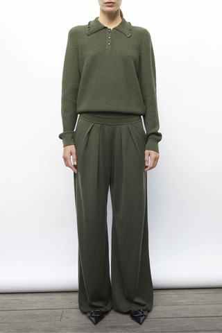 front profile model wearing Ding Light Textured Knit Polo khaki melange green Subtle waffle-knit Knit collar Ruffled finish Ribbing on the sleeve bottoms and body Buttoned placket Mother-of-pearl buttons