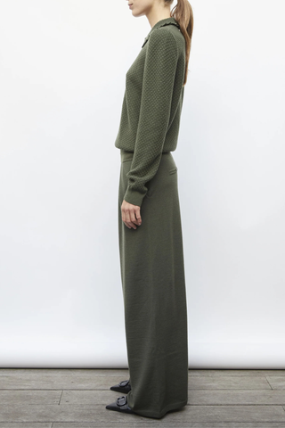 side profile model wearing Ding Light Textured Knit Polo khaki melange green Subtle waffle-knit Knit collar Ruffled finish Ribbing on the sleeve bottoms and body Buttoned placket Mother-of-pearl buttons