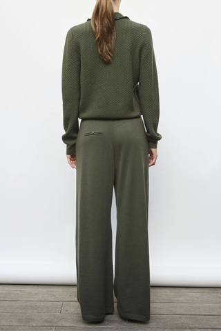back profile model wearing Ding Light Textured Knit Polo khaki melange green Subtle waffle-knit Knit collar Ruffled finish Ribbing on the sleeve bottoms and body Buttoned placket Mother-of-pearl buttons