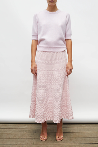 front profile model wearing Diva Pointelle Skirt Rose pink Structured knit
Wide zigzag-style waves
Pointelle knit
Wide scalloped waistband
Fine knit