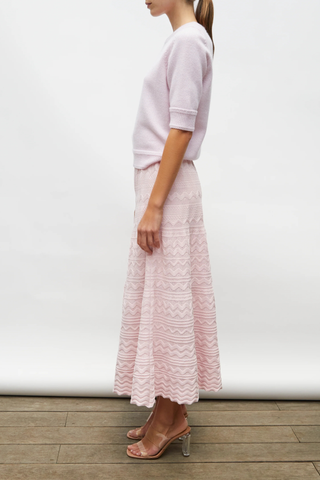 side profile model wearing Diva Pointelle Skirt Rose pink Structured knit
Wide zigzag-style waves
Pointelle knit
Wide scalloped waistband
Fine knit