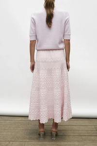 back profile model wearing Diva Pointelle Skirt Rose pink Structured knit
Wide zigzag-style waves
Pointelle knit
Wide scalloped waistband
Fine knit