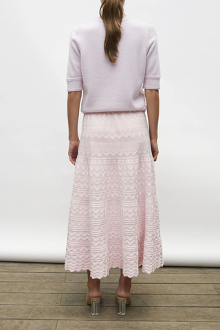 back profile model wearing Diva Pointelle Skirt Rose pink Structured knit
Wide zigzag-style waves
Pointelle knit
Wide scalloped waistband
Fine knit