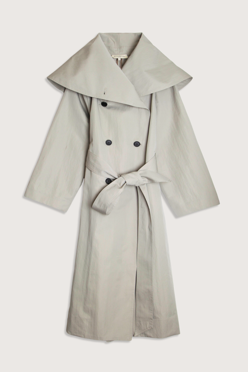 flat lay Dorothy Trench Coat fog grey 
Dramatic oversized shawl collar drapes across the shoulders 
Double breasted closure with contrast buttons and self tie belt at the waist
Welt pockets at front
 dropped shoulders and bracelet length sleeves mid calf length cotton nylon blend