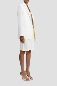 side profile model wearing Double Breasted Tailored Jacket ivory Fluid textured twill jacket
Oversized fit
Finishes below the hip
Front jet pockets with flaps
Welt chest pocket
Hidden button closure
Closed sleeve vent
Internal chest pocket
Double back vents