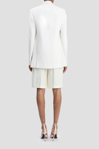 back profile model wearing Double Breasted Tailored Jacket ivory Fluid textured twill jacket
Oversized fit
Finishes below the hip
Front jet pockets with flaps
Welt chest pocket
Hidden button closure
Closed sleeve vent
Internal chest pocket
Double back vents