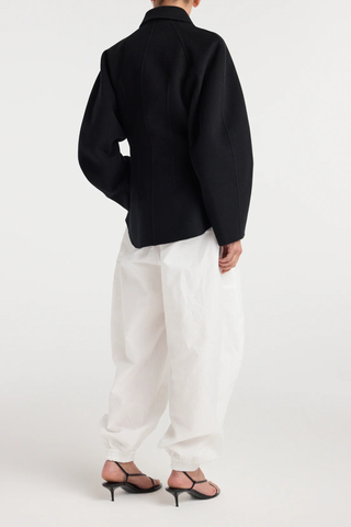 back profile model wearing Double Faced Sculptural Jacket Black
Cinched waist
Oversized sculptural sleeves
Four button closures
Side-seam welt pockets
Subtle front and back darts
95% wool 5% cashmere