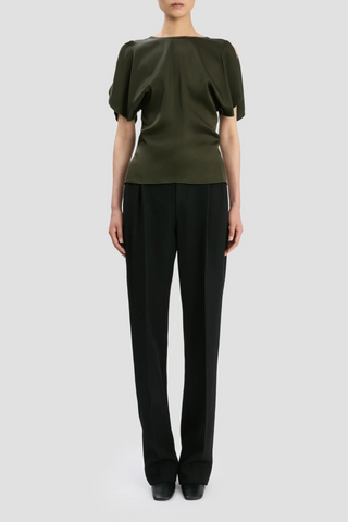 front profile model wearing Draped Sleeve Top Dark Olive Fitted over the hips with draped sleeves
Wide draped sleeves with contrast stitch detail
Front round neckline, deep v-neckline at the back