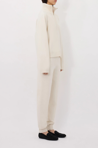 side profile model wearing Dries Stand Collar French Terry ivory cashmere stand collar front zip
