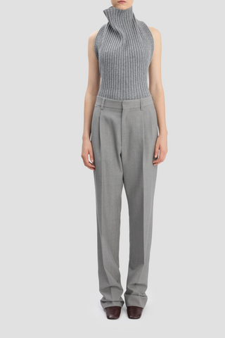 front profile model wearing Drop-Waist Straight Leg Trouser In Light Grey Melange virgin wool high waist front and low waist back design flat front 