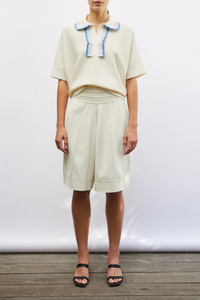 front profile model wearing Duc rick-rack edged collar polo natural multi with blue pink lavender collar details Fine knit top
Relaxed cut
Iconic garter-stitch knit
Collar decorated with three narrow, graded-color rickracks
Milano edges at the bottom
