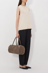 side profile model wearing Effy Boxy Sweater Vest Natural Sleeveless sweater
Boxy fit
Rolled stand collar
Ribbed details on the neckline, armholes and hem