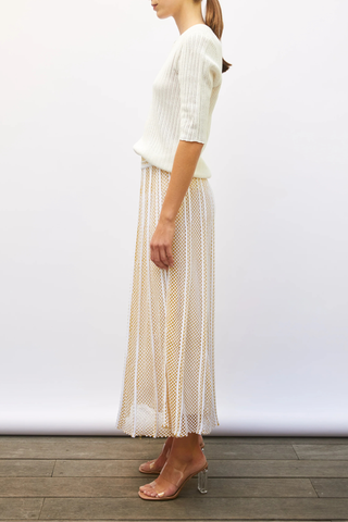 side profile model wearing Elegante Mesh Midi Skirt milk yellow Fine knit skirt
Modern honeycomb knit
Long, flared cut
Light and fluid
Perfect drape
Fully lined
Waistband knitted in a delicate honeycomb jacquard