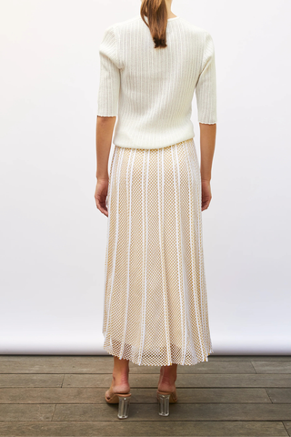 back profile model wearing Elegante Mesh Midi Skirt milk yellow Fine knit skirt
Modern honeycomb knit
Long, flared cut
Light and fluid
Perfect drape
Fully lined
Waistband knitted in a delicate honeycomb jacquard