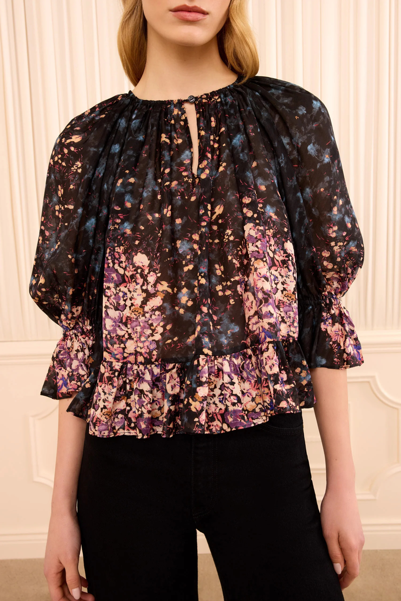 front profile model wearing Elise Silk Blouse eclipse navy and pink Scattered bouquet motif
Rendered in paneled sections that shift in density, color, and shape
Ruffles at the sleeves and hem
100% Silk jacquard
Crew ruffled neckline
Pull-on back neck keyhole
Short sleeve
Draped throughout