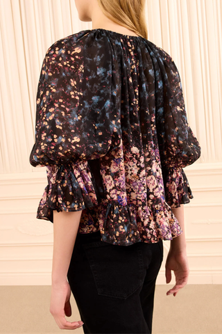 back profile model wearing Elise Silk Blouse eclipse navy and pink Scattered bouquet motif
Rendered in paneled sections that shift in density, color, and shape
Ruffles at the sleeves and hem
100% Silk jacquard
Crew ruffled neckline
Pull-on back neck keyhole
Short sleeve
Draped throughout