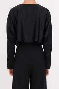 back profile model wearing Emilia Crop Top Black long sleeve raw hem