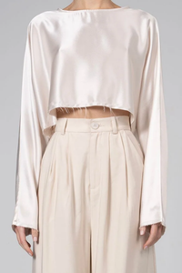 front profile model wearing Emilia Crop Top Champagne long sleeve raw hem