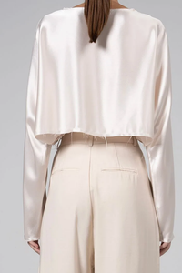 back profile model wearing Emilia Crop Top Champagne long sleeve raw hem