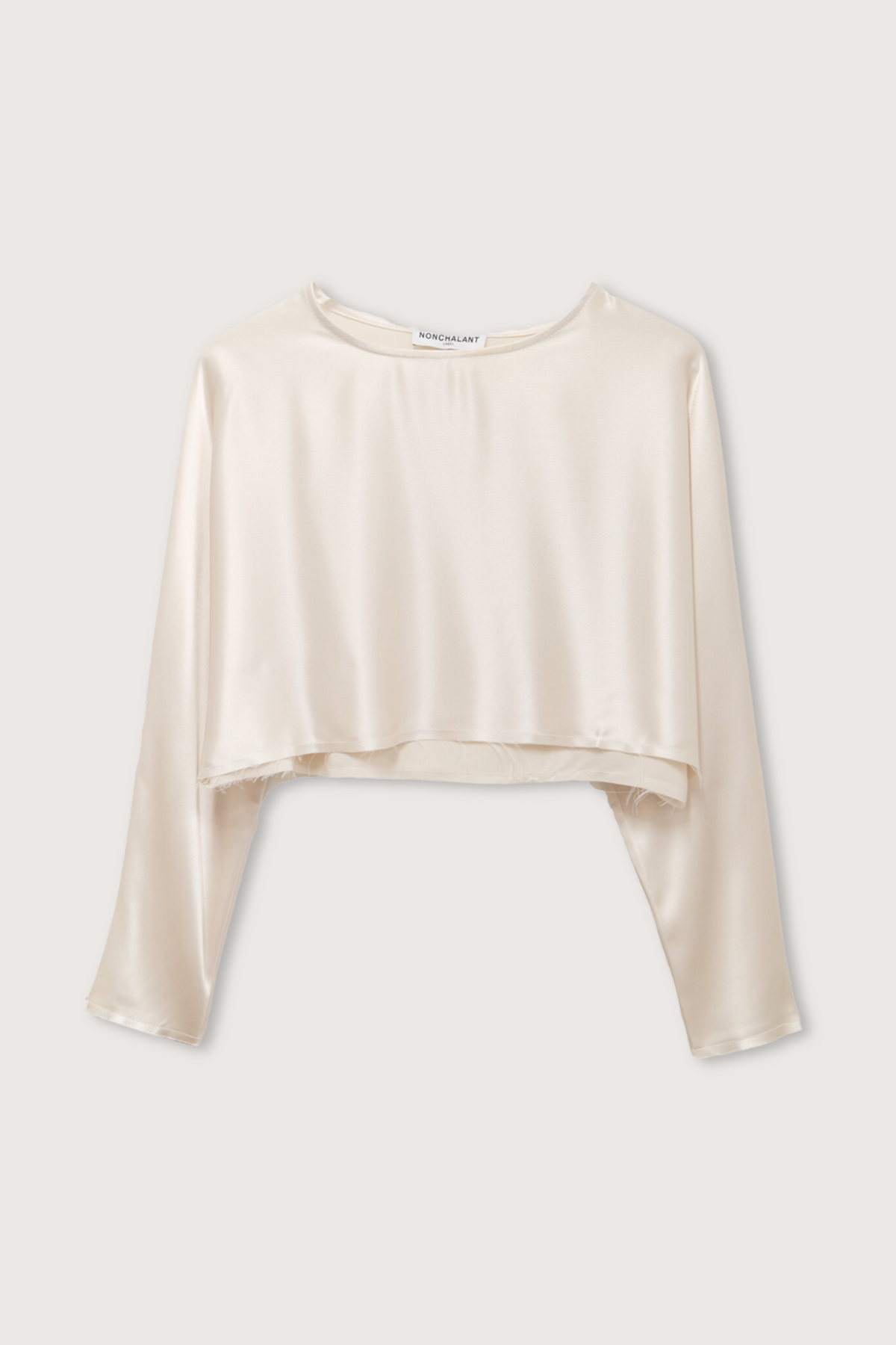 flat lay Emilia Crop Top Champagne long sleeve raw hem