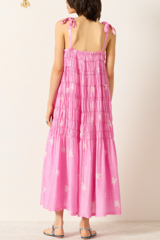 back profile model wearing Emrys Pink Jasmin Silk Dress medium pink Cut from hand-loomed silk
Relaxed maxi dress
Fluid drape
Ruched tiers
Tie shoulder straps
Hand-block-printed
Asymmetrical jasmine motif