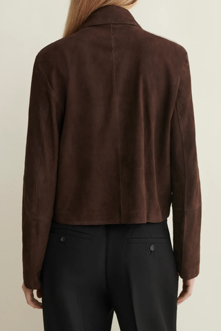 back profile model wearing Emy Suede Jacket Mud Brown  button down jacket
Cropped length and detailed with horn button closure and front pockets
Fits true to size, take your normal size
Dropped shoulder seam
100% goat suede