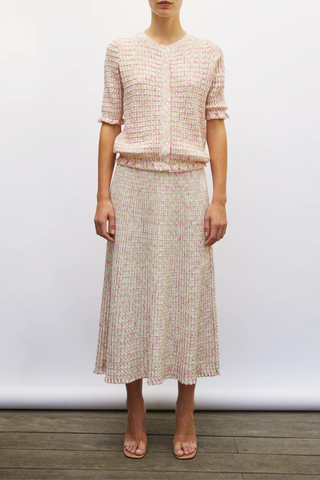 front profile model wearing Enjoue Mini Origami Knit Cardigan Natural/Pink natural pink multi Short sleeves
Lovely volume
Ruffled trim at the waist and cuffs
Origami knit
Round neckline
Front closure with small buttons