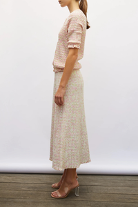 side profile model wearing Enjoue Mini Origami Knit Cardigan Natural/Pink natural pink multi Short sleeves
Lovely volume
Ruffled trim at the waist and cuffs
Origami knit
Round neckline
Front closure with small buttons