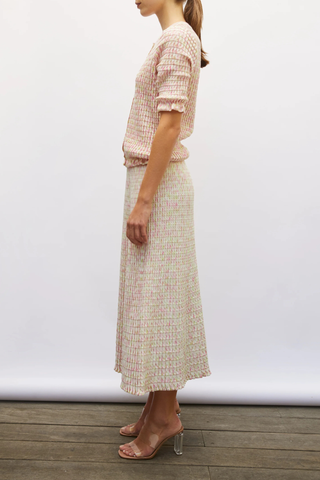 side profile model wearing Enjoue Mini Origami Knit Cardigan Natural/Pink natural pink multi Short sleeves
Lovely volume
Ruffled trim at the waist and cuffs
Origami knit
Round neckline
Front closure with small buttons