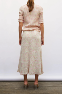 back profile model wearing Enjoue Mini Origami Knit Cardigan Natural/Pink natural pink multi Short sleeves
Lovely volume
Ruffled trim at the waist and cuffs
Origami knit
Round neckline
Front closure with small buttons