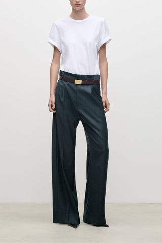 front profile model wearing  Ethel Classic Wool Pant Tailored trouser marsh green
Refined construction
Mid waist
Pleat detail at waist
Dual belt loop for a regular or slim belt allowing the trouser to be worn mid waist or as a paperbag style
Traditional tailored trouser fastening with side entry and back jet pockets
100% Virgin Wool