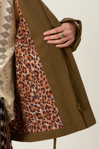 close up lining detail  Evelyn Olive Branch Army Jacket dark green Cotton twill
Utility style jacket
Flap pockets
Drawstring waist
Trimmed with hand embroidery and lined in leopard print
Blue embroidery details on the shoulder and flap pockets
100% Khadi Cotton
Snap Front with hidden front zip