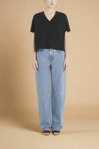 back profile model wearing black boxy supima cotton v-neck t-shirt