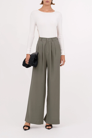 front profile model wearing Fabi Pant Olive high rise pleated wide leg