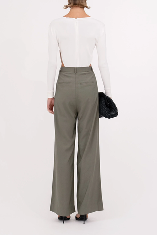 back profile model wearing Fabi Pant Olive high rise pleated wide leg