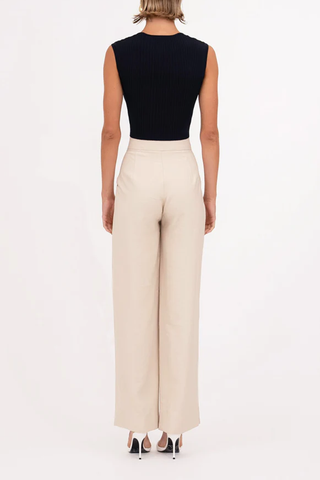 back profile model wearing Fallon Pant oat cream high waisted straight leg