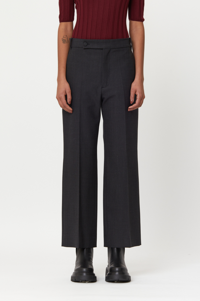front profile model wearing  flared wool pants anthracite grey, Regular waist, Lined button fastening, Belt loops, Concealed side slip pockets, Buttoned back welt pockets 