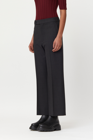 side profile model wearing  flared wool pants anthracite grey, Regular waist, Lined button fastening, Belt loops, Concealed side slip pockets, Buttoned back welt pockets 