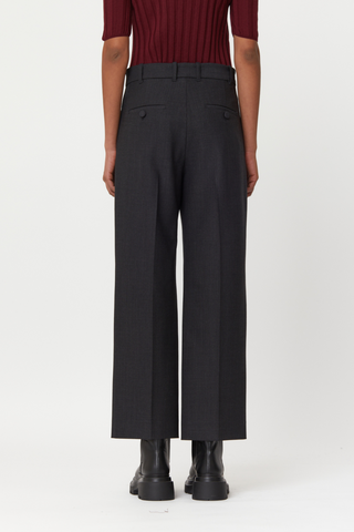 back profile model wearing  flared wool pants anthracite grey, Regular waist, Lined button fastening, Belt loops, Concealed side slip pockets, Buttoned back welt pockets 