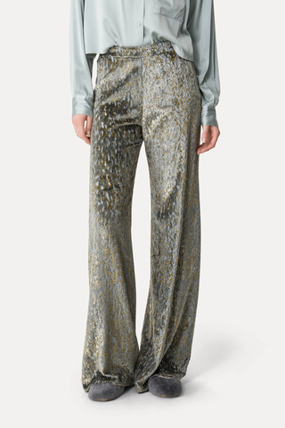 front profile model wearing Flared Trousers stone grey Silk–and–viscose velvet Embellished with a devoré pattern Elasticated casing at the back of the waist