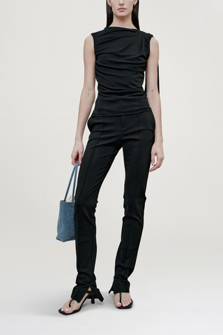 front profile model wearing  Floriana Matte Jersey Top Sleeveless top
Slinky matte jersey
Diagonal ruching across the body from a high neckline
Fitted through the torso with a long sash at the shoulder
Light internal support at chest
100% Viscose