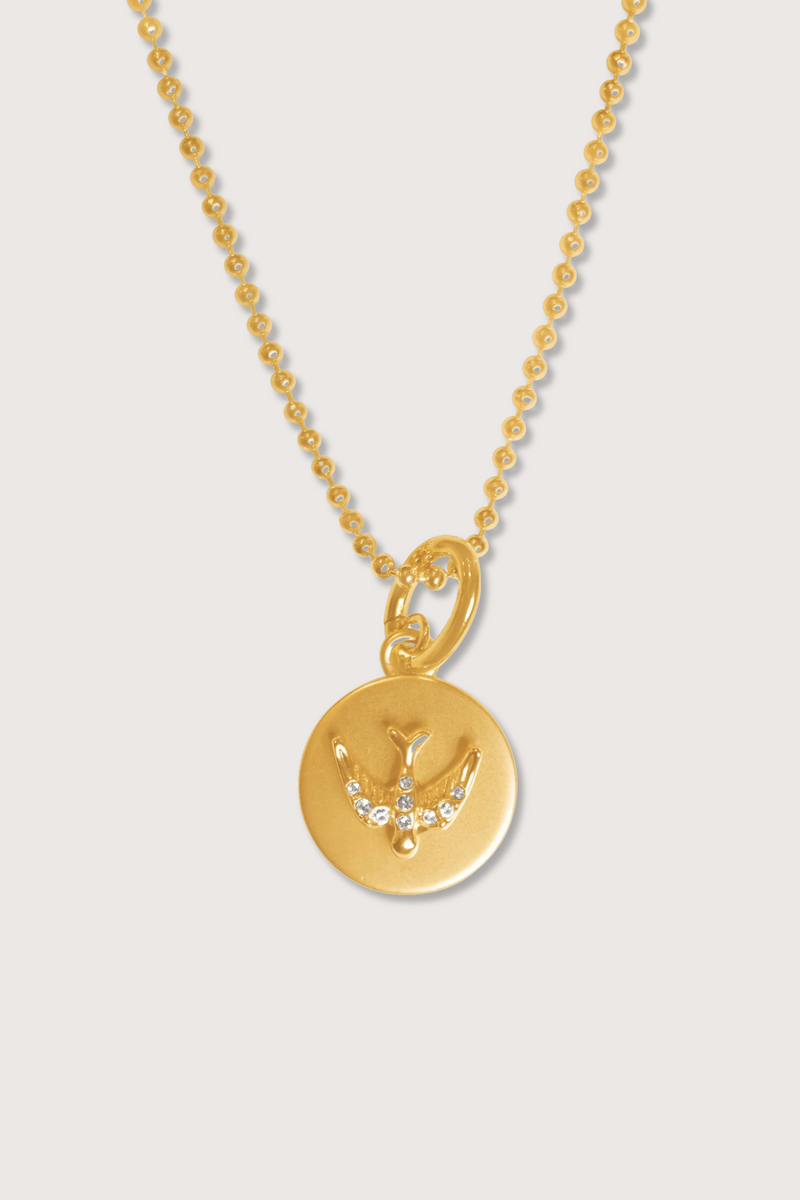 flat lay Free Spirit Bird Coin Charm Necklace gold