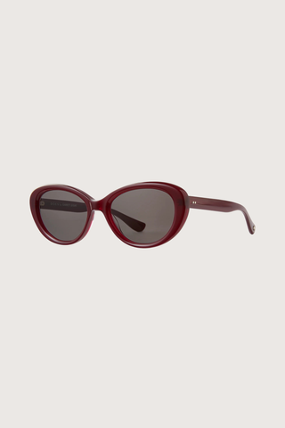 angled profile GLCO x Doen Ingenue Sun Lipstick red frame  dark grey lens Thicker, more expressive cat-eye