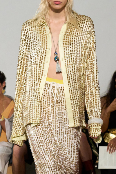 front profile model wearing Gabriel Translucent Beaded Silk pear gold Long Sleeve
Micro pailettes throughout with beads
100% Silk&nbsp;
Button front closure