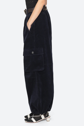 side profile model wearing Garrett Pants navy Relaxed cargo-inspired silhouette
Finished with a removable leather belt
Adjustable drawstring hems
Side pockets with button closure
98% cotton, 2% spandex
Button and zipper closure
Relaxed fit
Slim waist