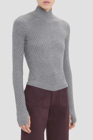 side profile model wearing Georgia Sweater grey marl Ribbed 
Tonal VB tab on the back neck
High Neck & high hip length
Fine merino wool in rib stich
VB embroidered logo
100% Merino Wool