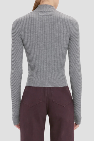 back profile model wearing Georgia Sweater grey marl Ribbed 
Tonal VB tab on the back neck
High Neck & high hip length
Fine merino wool in rib stich
VB embroidered logo
100% Merino Wool