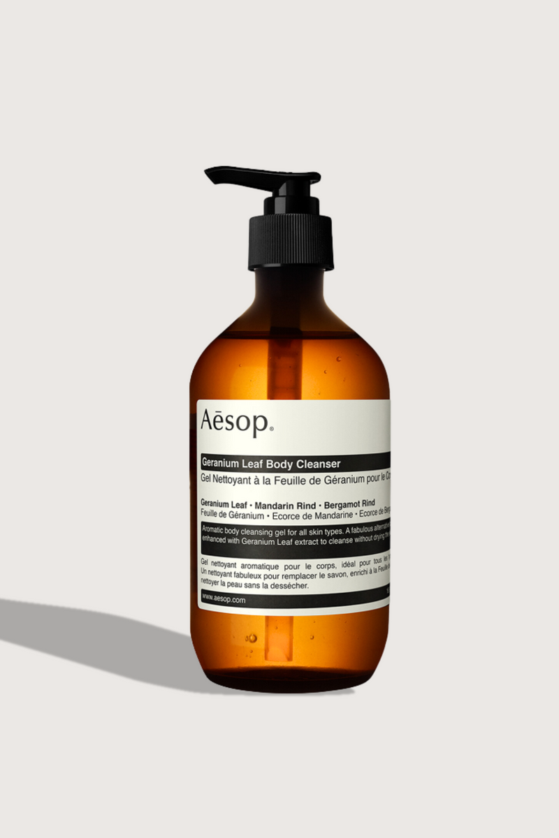 flat lay Geranium Leaf Body Cleanser 500mL brown bottle with pump