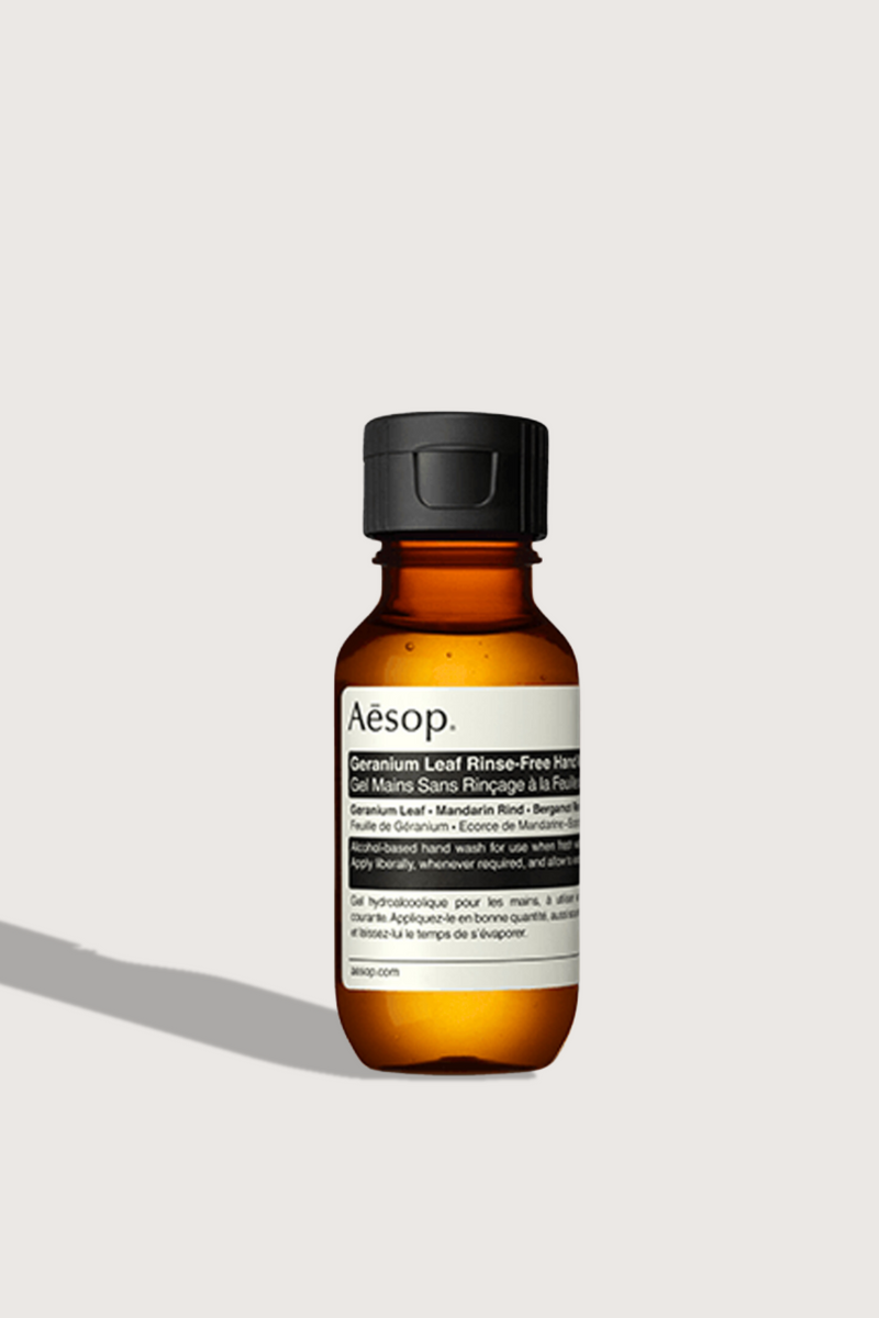 flat lay Geranium Leaf Rinse-Free Hand Wash 50 mL brown bottle with cap